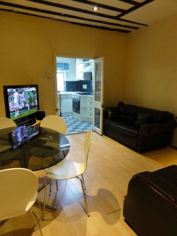 Property photo 1 of 10 A Cozy Living Room Featuring A Television, A Round...