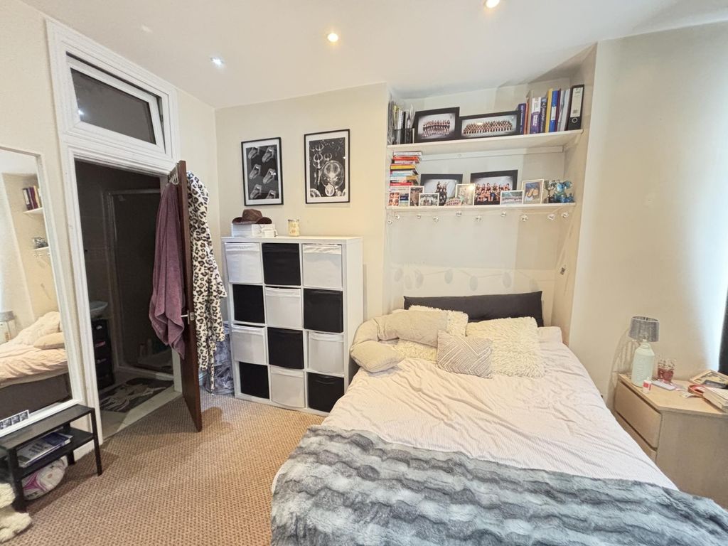 Property photo 3 of 18 A Bright And Cozy Bedroom Featuring A Comfortable ...