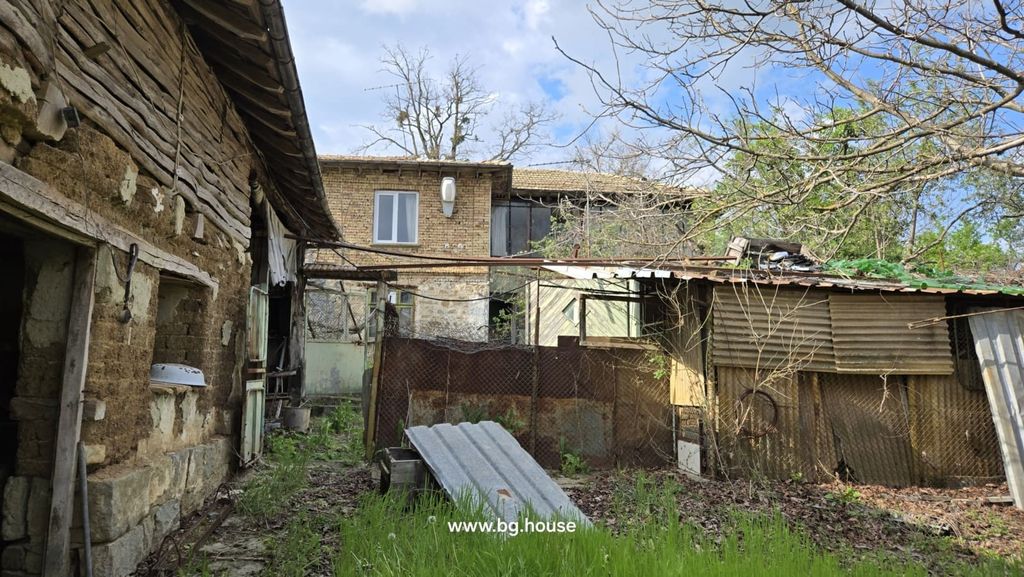 Property photo 2 of 100 The Rear Yard Area With Old Outbuildings Made Of Wood And Metal Sheets, And The Back Of The Two-Storey House With Windows And Doors.