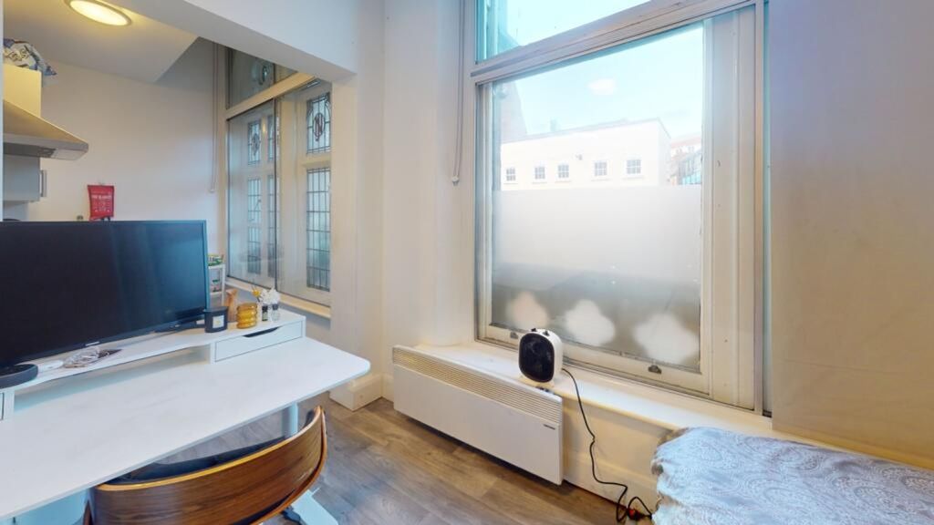 Property photo 3 of 4 This Inviting Communal Workspace Features Large Wi...