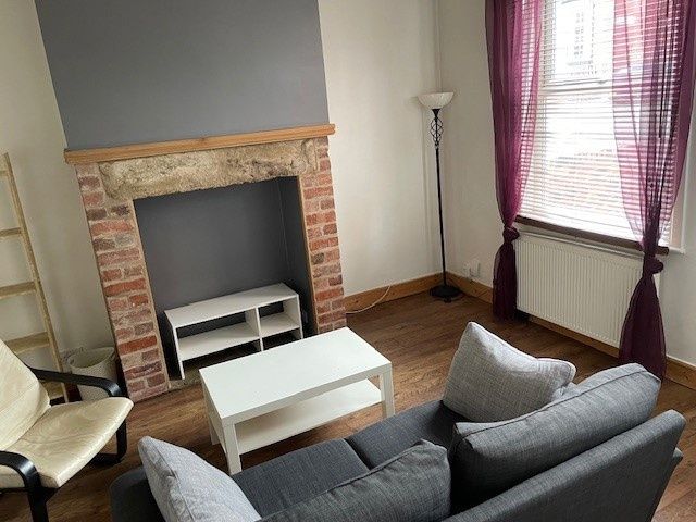 Property photo 3 of 9 A Cozy Living Room Featuring A Comfortable Grey So...