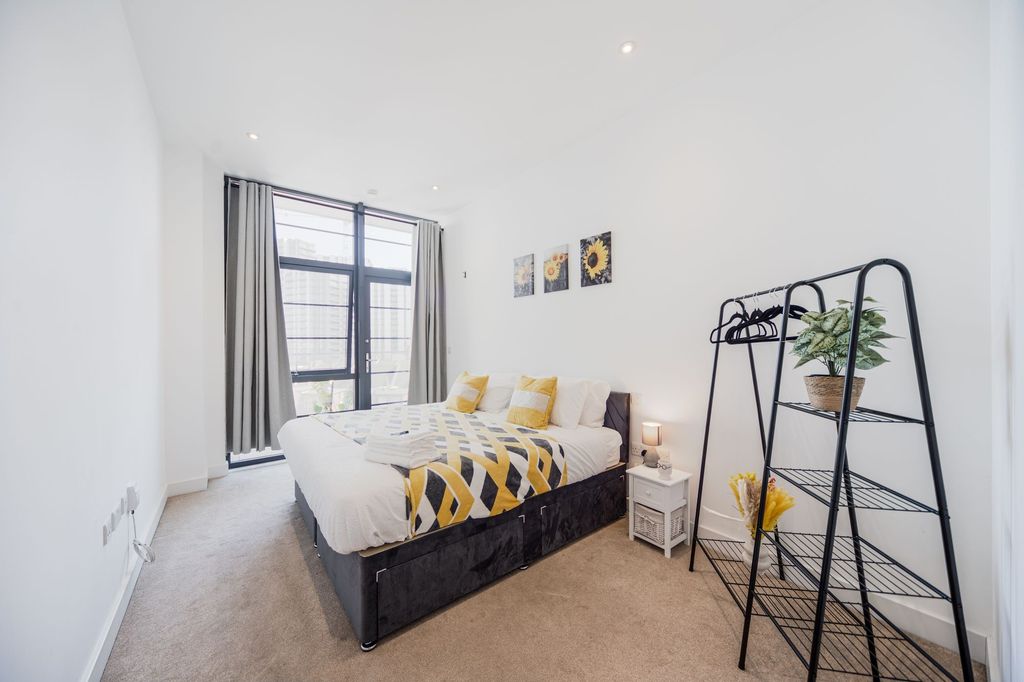 Property photo 2 of 7 Bright And Modern Master Bedroom Featuring A Large...