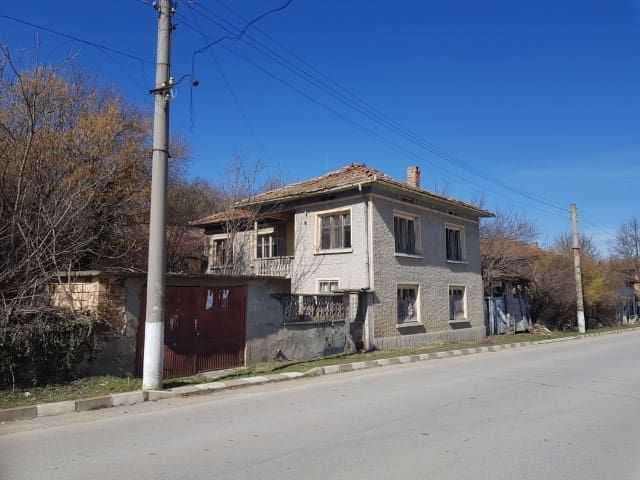 Property photo 3 of 39 Side Perspective Showing Textured Walls, Tiled Roof, And Wooden Gates Beside The House