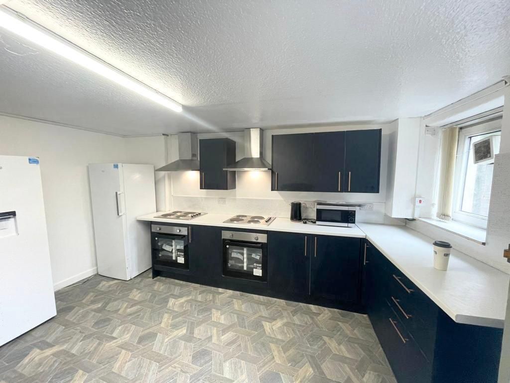 Property photo 2 of 9 Modern Kitchen With Sleek Dark Cabinets...