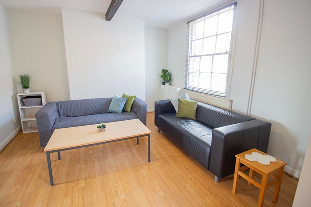 Property photo 1 of 7 Bright And Inviting Living Room Featuring Modern F...