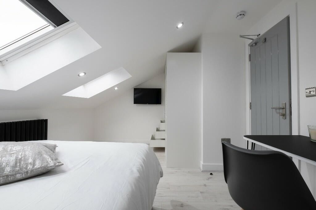 Property photo 3 of 11 This Stylish Double Bedroom Features Ample Natural...