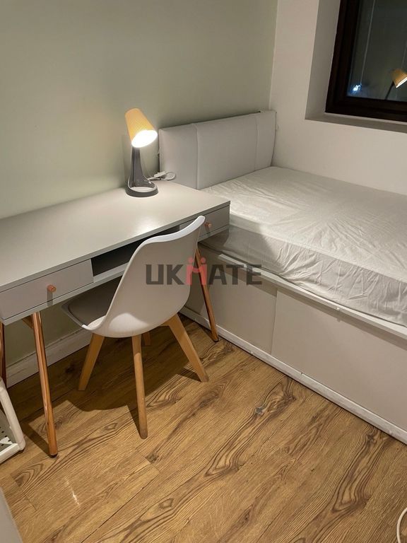 Property photo 3 of 9 A Cozy Single Bedroom Featuring A Simple Bed, A St...