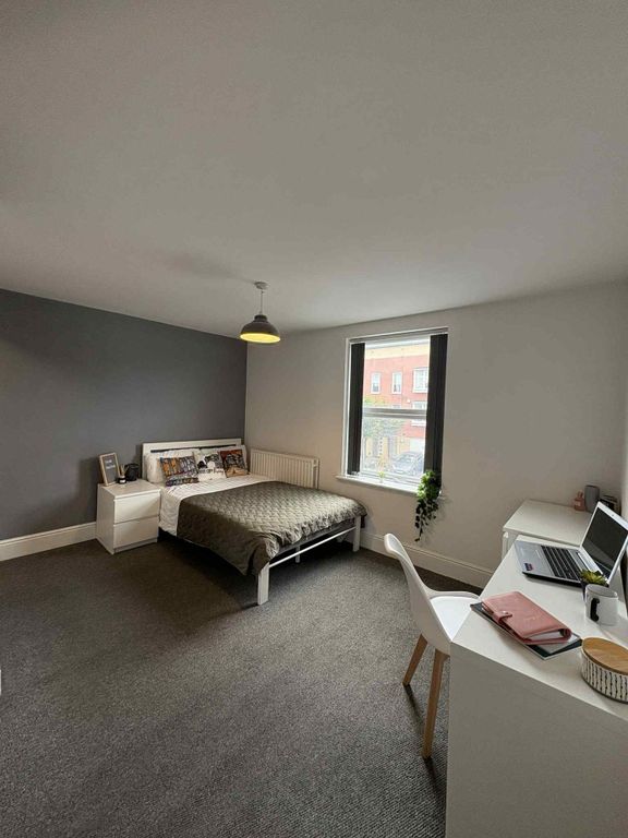 Property photo 1 of 14 A Spacious And Bright Bedroom Featuring A Comforta...