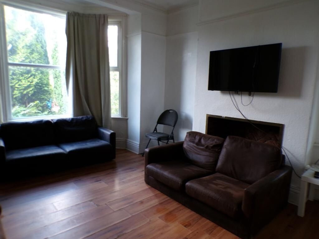 Property photo 1 of 10 Bright And Inviting Living Room Featuring Comforta...