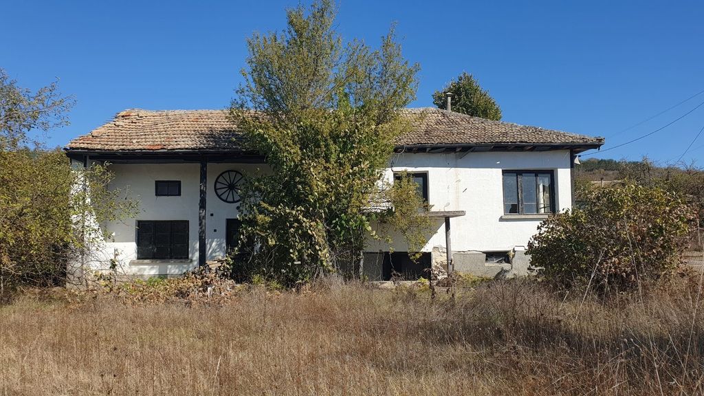 Property photo 2 of 43 View Of The White House With A Tiled Roof, A Tree In Front, And Dry Grass In The Yard