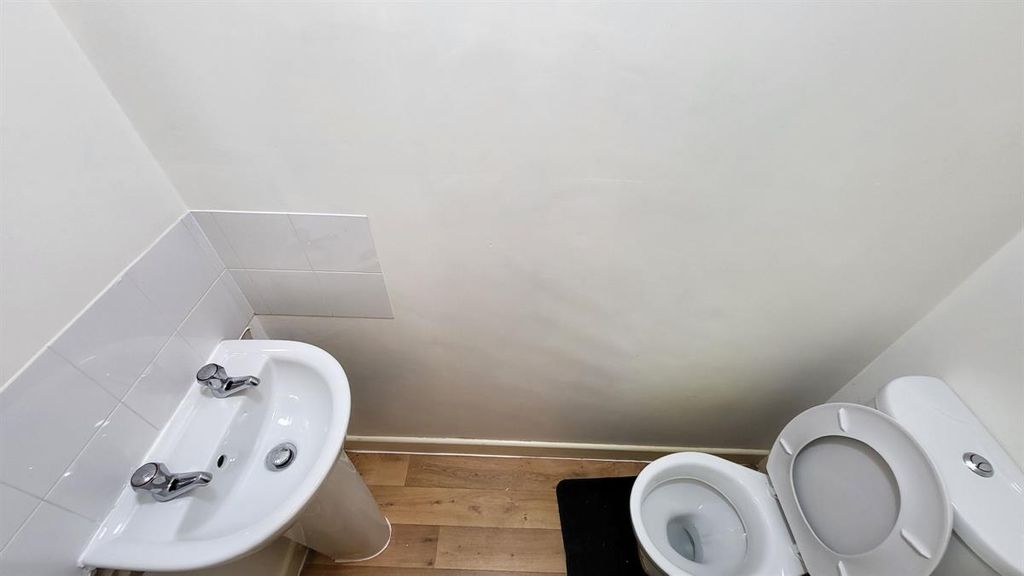Property photo 1 of 15 A Clean And Simple Single Toilet With A White Sink...