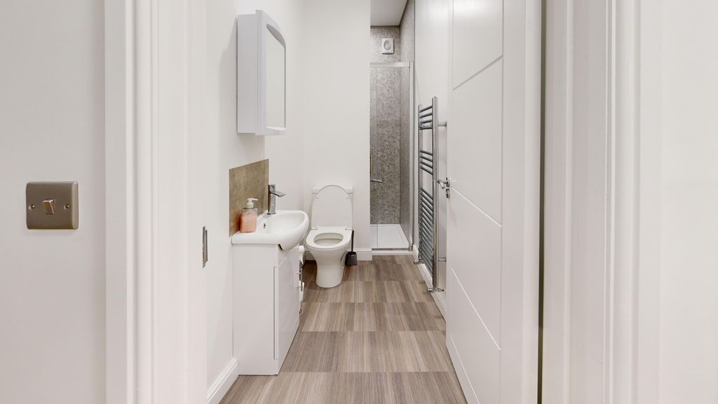 Property photo 3 of 4 A Modern Bathroom Featuring Sleek Fixtures And A S...