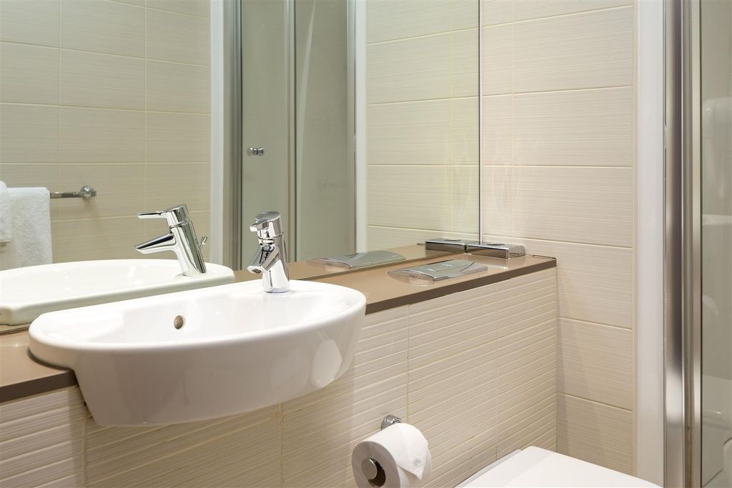 Property photo 3 of 5 Bright, Modern Bathroom With A Wall-Mounted Basin,...