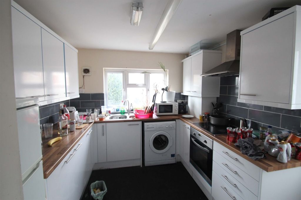 Property photo 2 of 4 Bright Galley Kitchen With White Cabinets, Wooden ...