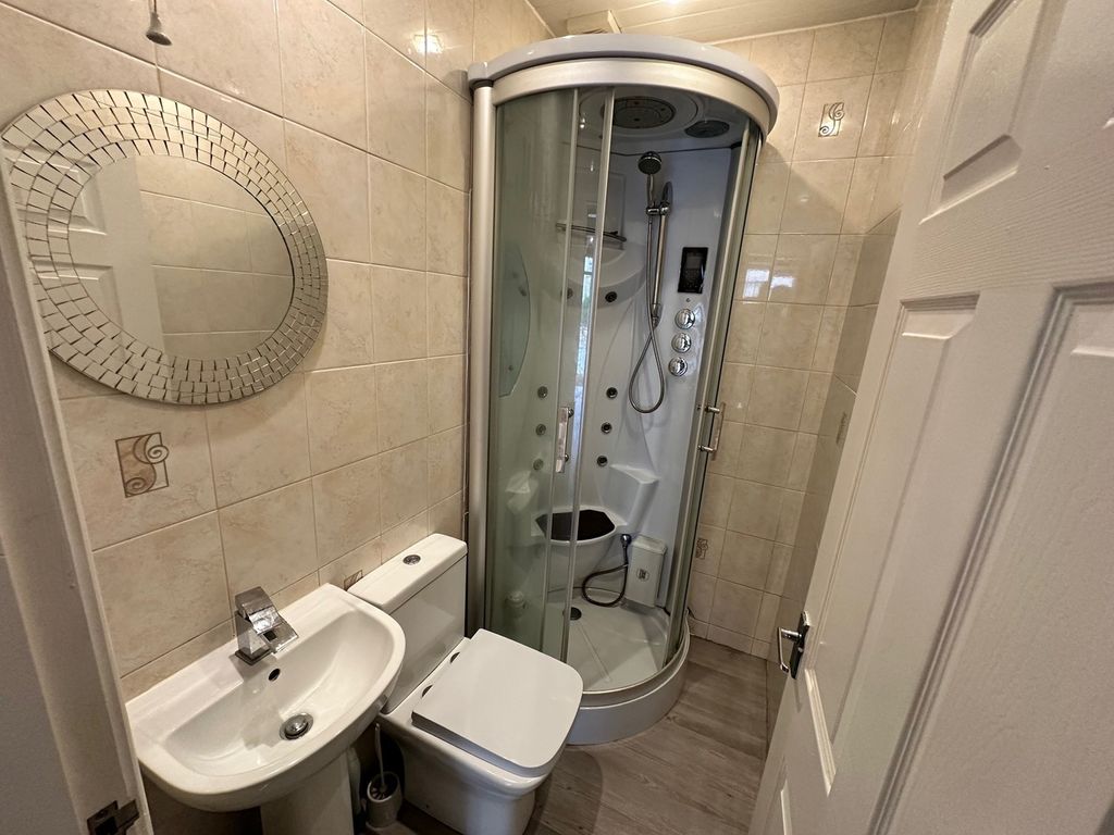 Property photo 1 of 6 A Modern Bathroom Featuring A Sleek Shower Unit, S...