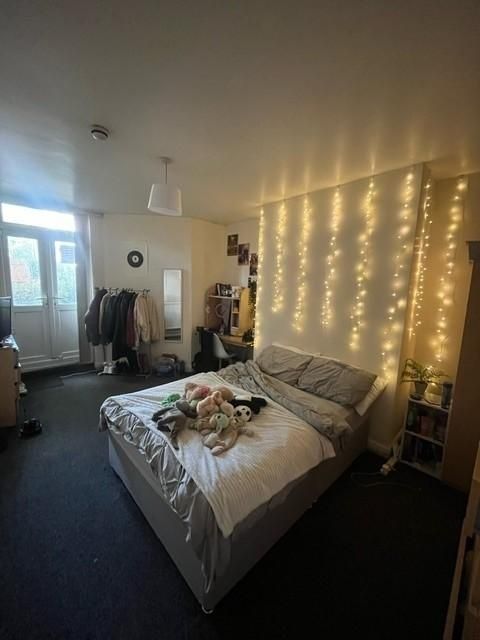 Property photo 2 of 8 A Cozy Bedroom Featuring A Comfortable Bed With Pl...