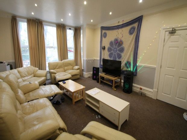 Property photo 3 of 20 A Spacious And Well-Lit Living Room Featuring Comf...