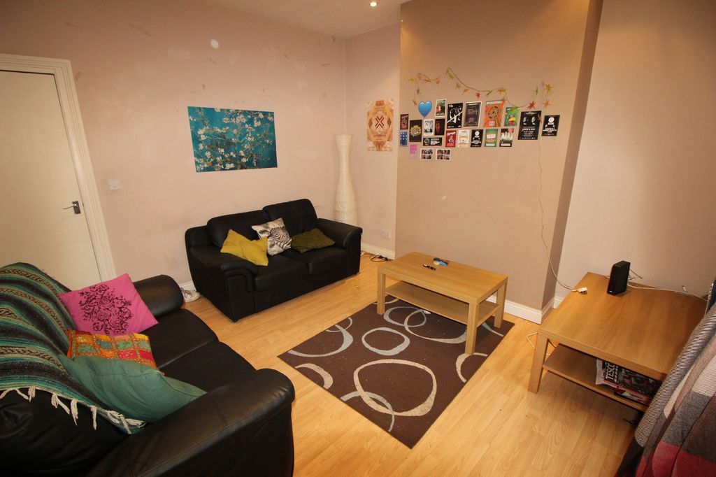 Property photo 2 of 6 A Cozy Living Room Featuring Two Black Leather Sof...