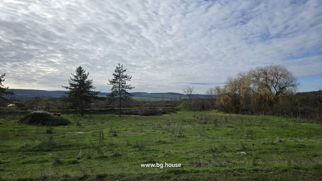 Property photo 3 of 48 Open Grassy Field With Some Bushes And Trees In The Distance Under A Cloudy Sky