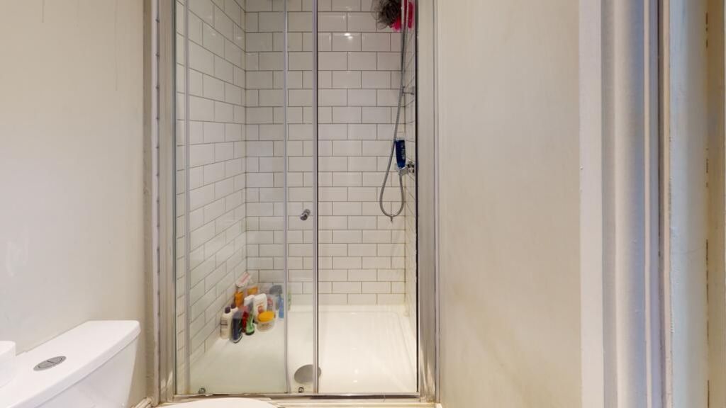 Property photo 1 of 8 Modern Bathroom Featuring A Sleek Shower Enclosure...