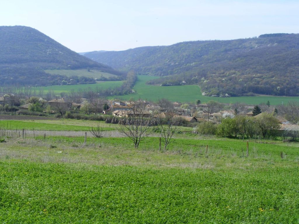 Property photo 2 of 39 Green Fields With Scattered Trees And A Village Nestled At The Base Of Forested Hills
