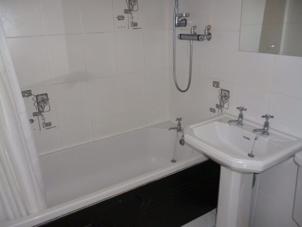 Property photo 3 of 5 Well-Maintained Bathroom With A Bath, Overhead Sho...