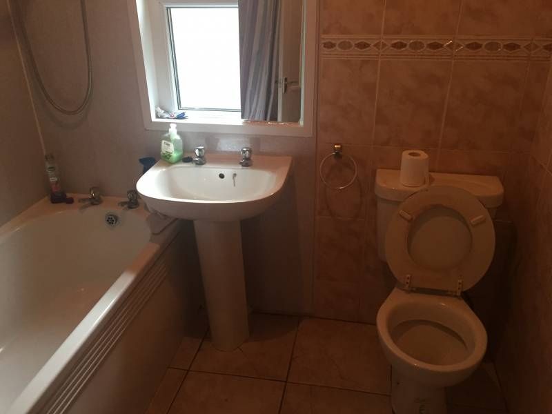 Property photo 3 of 11 Bright Bathroom With Bathtub And Tiled Walls...