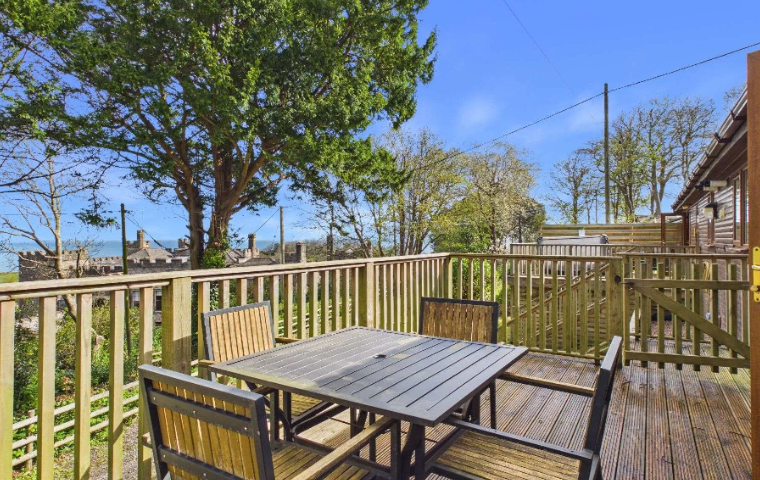 Property photo 2 of 10 Outdoor Dining Area On The Lodge Decking With Coastal And Castle Views