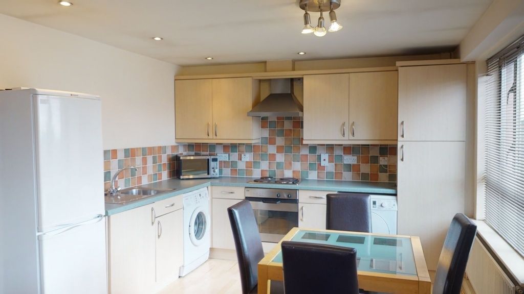 Property photo 3 of 6 Bright And Modern Kitchen Featuring A Tiled Backsp...