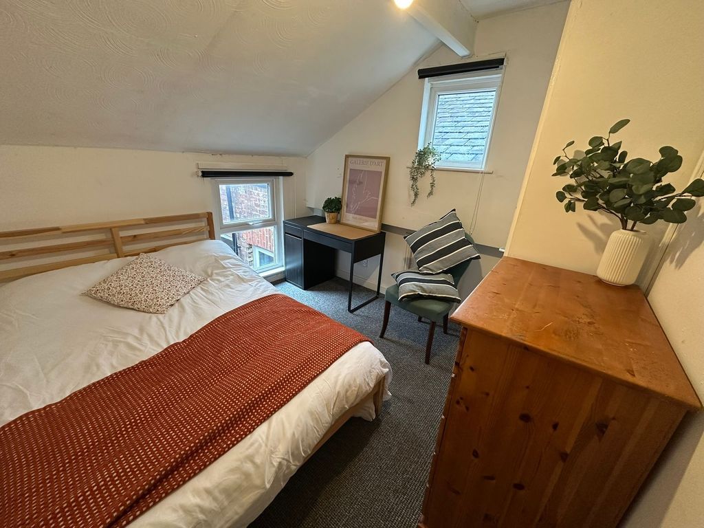 Property photo 3 of 23 Cozy Bedroom Featuring A Double Bed With A Wooden ...