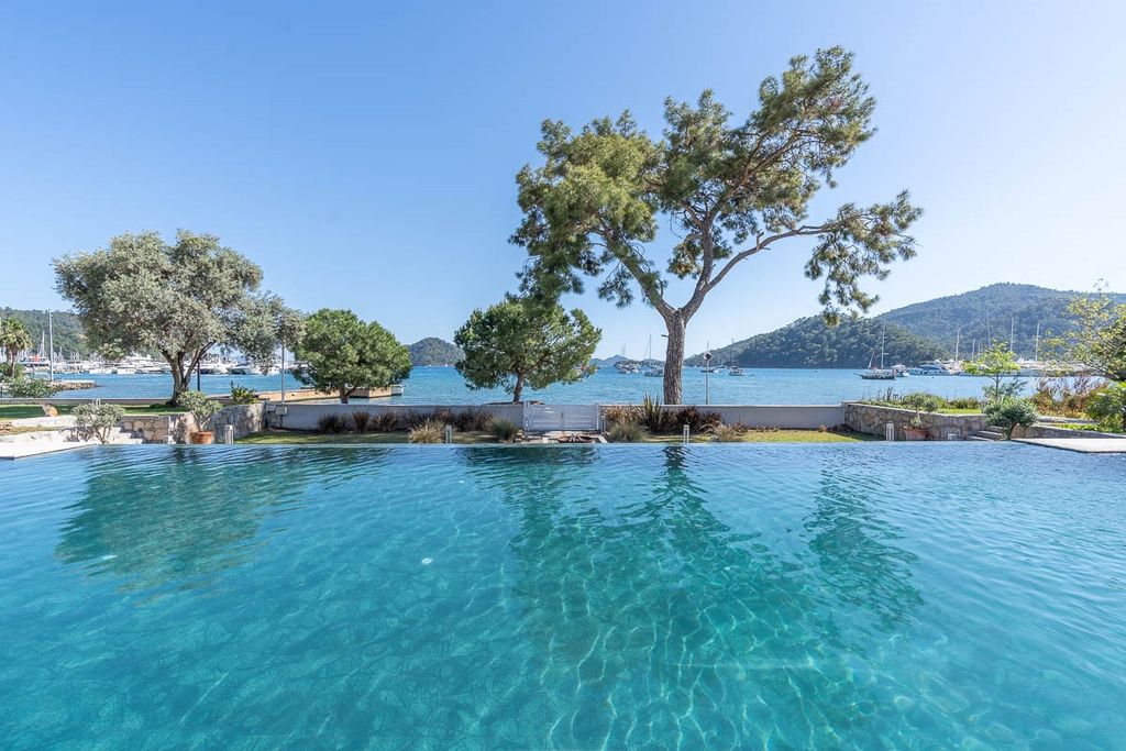 Property photo 2 of 27 An Attractive Seafront Garden Apartment In Gocek For Sale - Shared Infinity Pool Next To The Sea
