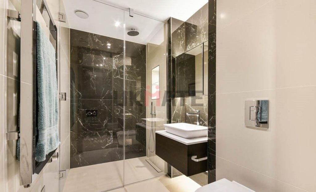 Property photo 2 of 9 Modern Bathroom With Sleek Black Marble Walls, A S...