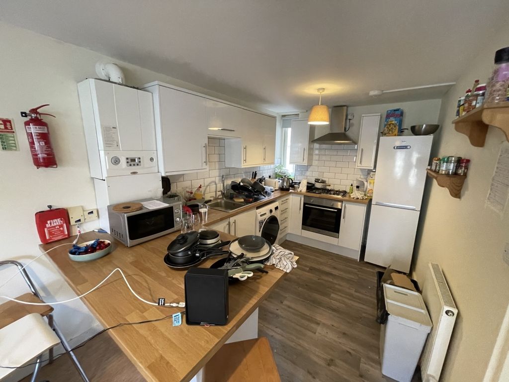 Property photo 2 of 10 Bright And Practical Kitchen Featuring Modern Whit...