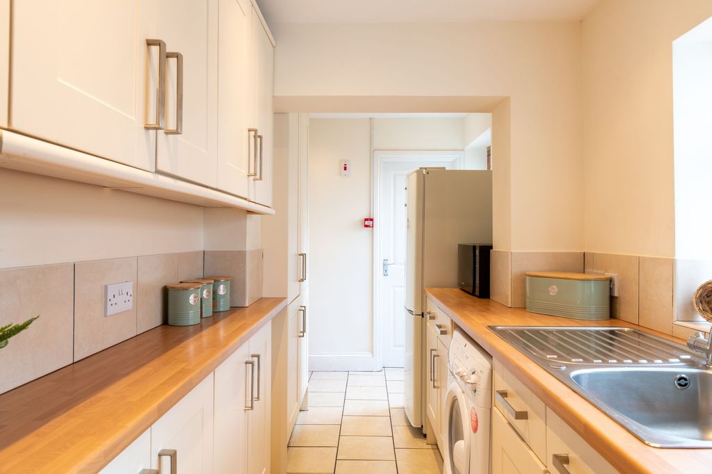 Property photo 2 of 11 Bright, Modern Galley Kitchen With Wood-Effect Wor...