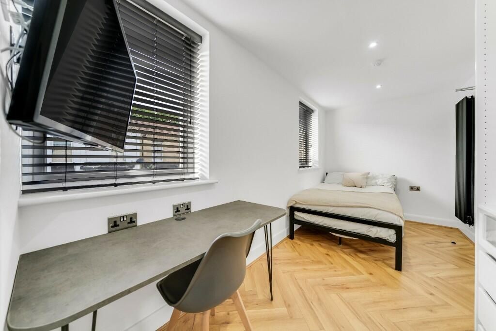 Property photo 3 of 10 Bright And Modern Living Room Featuring Ample Natu...