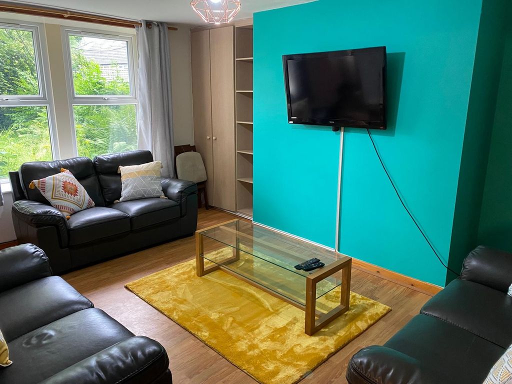 Property photo 2 of 5 This Inviting Living Room Features Modern Furnishi...