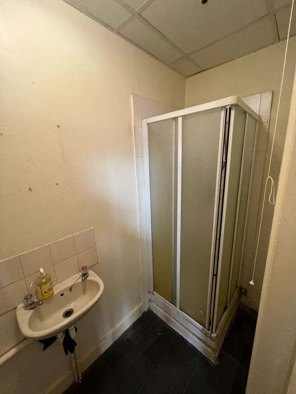 Property photo 3 of 4 A Compact Bathroom Featuring A Corner Shower Cubic...