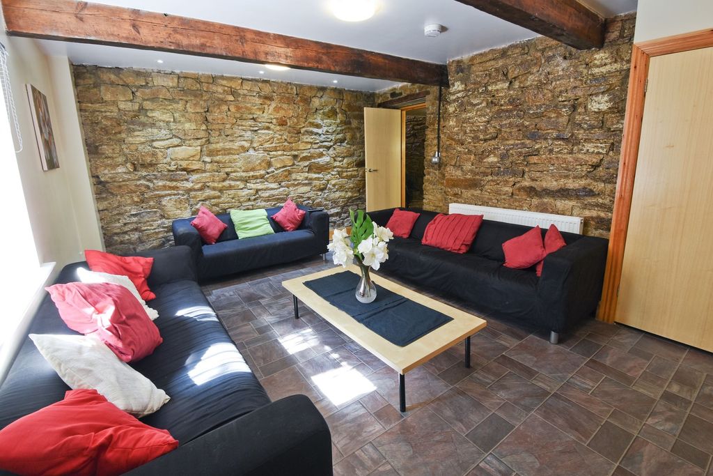 Property photo 3 of 17 A Cozy And Stylish Living Room Featuring Exposed S...