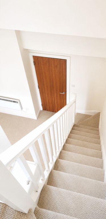 Property photo 3 of 8 Bright, Carpeted Staircase With Modern White Trim...