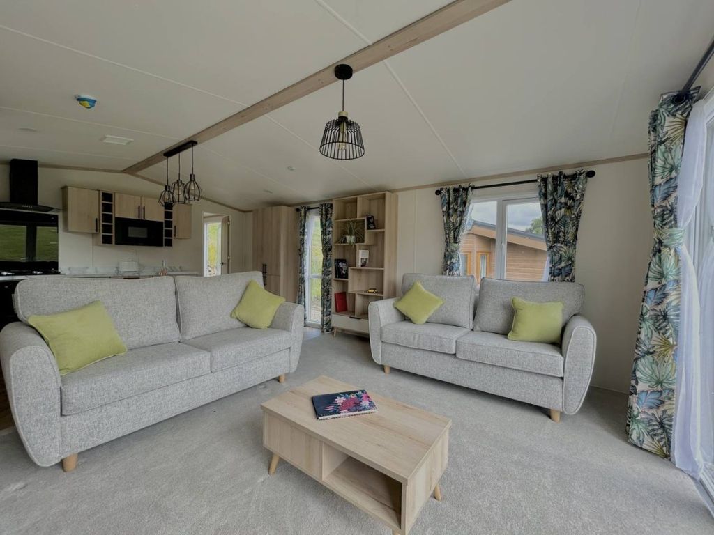 Property photo 2 of 12 Regal Charmouth Open Plan Lounge With Freestanding Sofas And Botanical Curtains