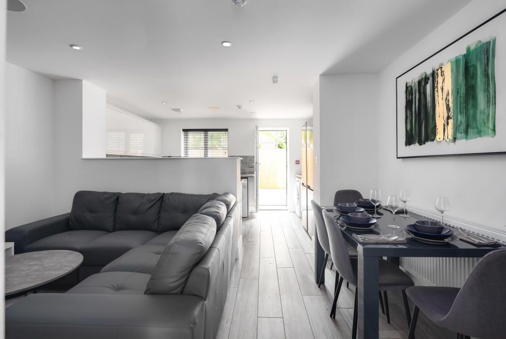 Property photo 1 of 14 A Spacious And Modern Living Room With Ample Natur...