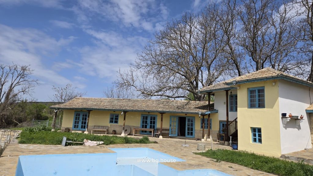 Property photo 3 of 99 Wide Exterior View Of Yellow Rural House With Blue Windows And Empty Swimming Pool