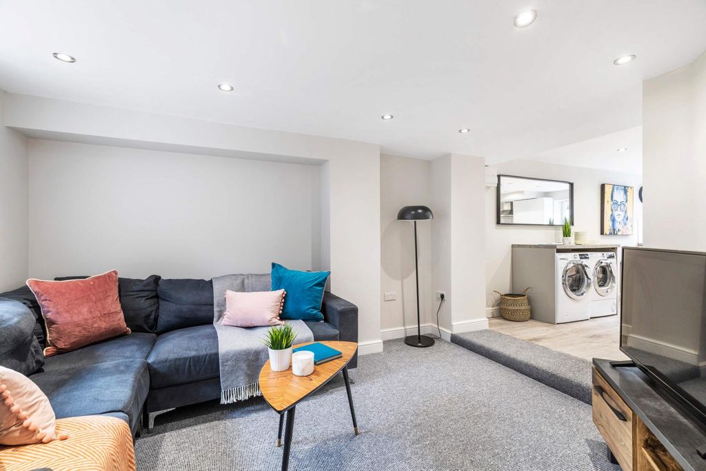 Property photo 1 of 9 Bright And Spacious Living Room Featuring Comforta...