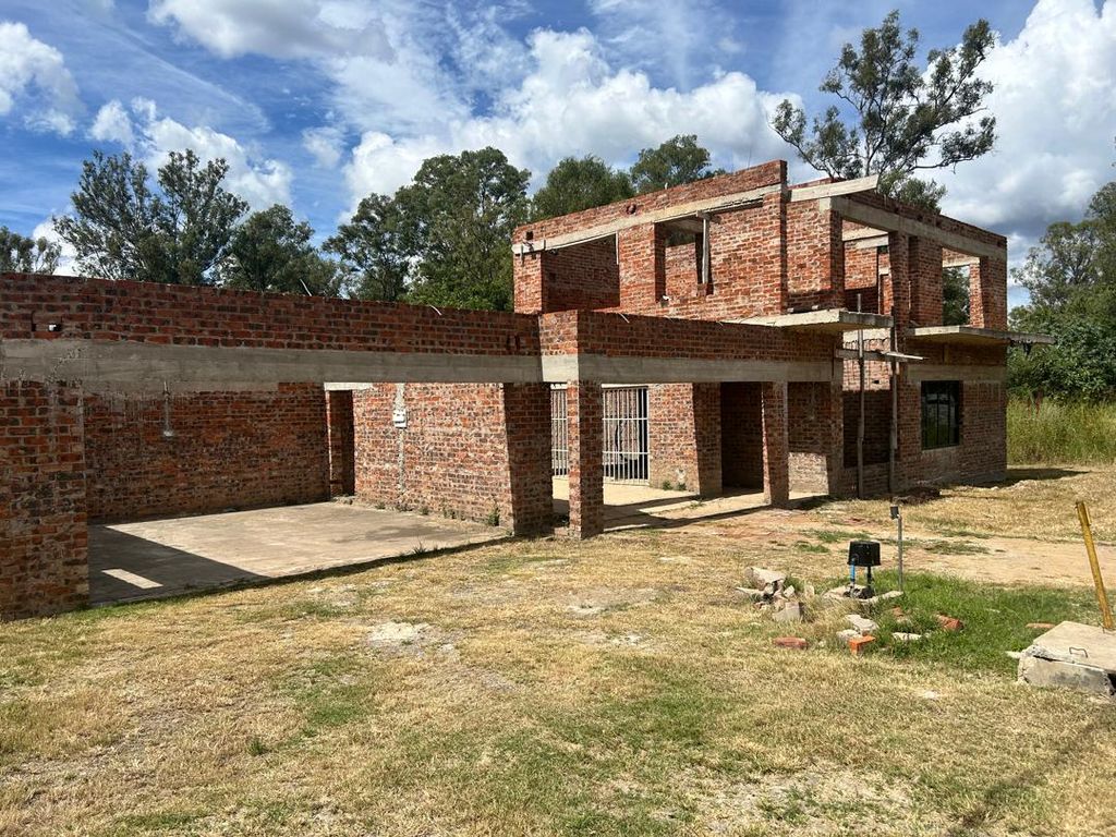 Property photo 2 of 8 Unfinished Two-Story Brick House Under Construction In A Grassy Yard With Exposed Concrete Beams And Empty Window Openings.