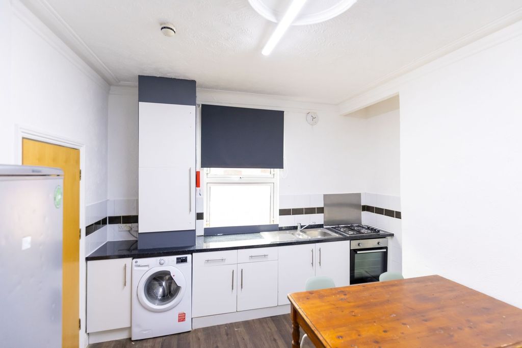 Property photo 3 of 8 Bright And Functional Kitchen Featuring Modern App...