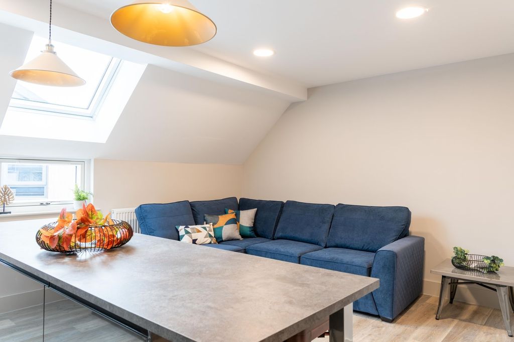 Property photo 3 of 13 A Spacious And Modern Living Room Featuring A Larg...