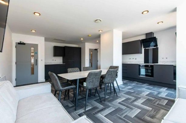 Property photo 3 of 6 A Modern Kitchen And Dining Area With Sleek Black ...