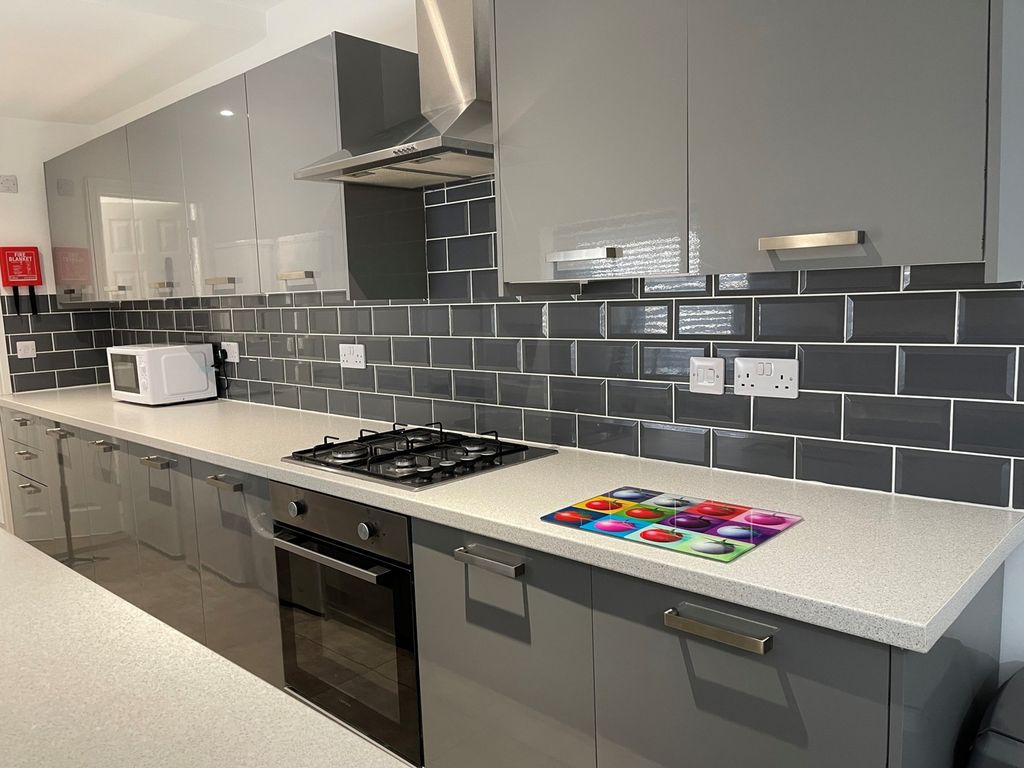 Property photo 2 of 5 A Modern And Spacious Kitchen With Sleek Grey Cabi...