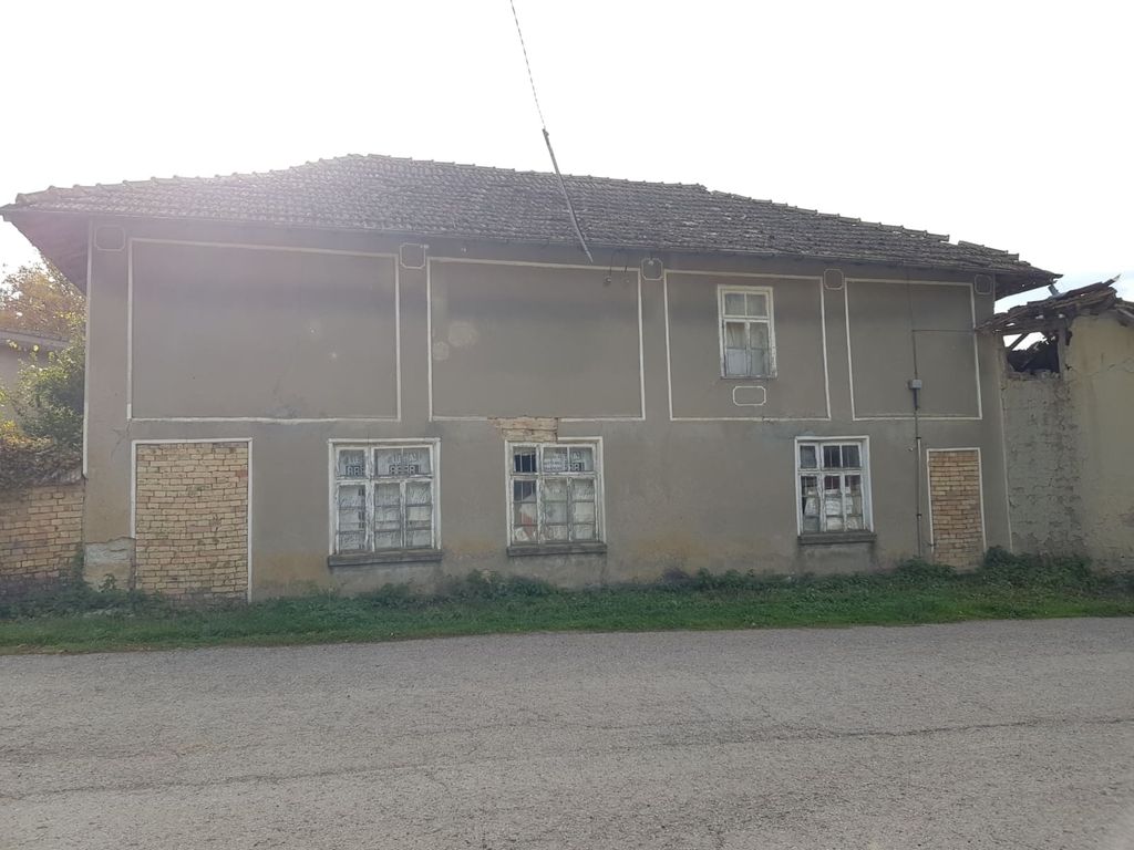 Property photo 1 of 13 Exterior View Of The Two-Storey House Showing The Front Facade With Three Windows And A Tiled Roof