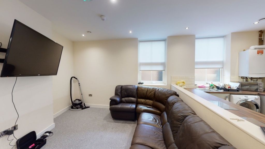 Property photo 1 of 6 A Cozy Living Room Featuring A Large Brown Leather...